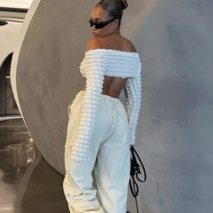 Detailed texture of white off-shoulder bubble crop top paired with beige cargo pants