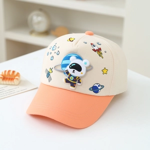 Detail of space bear rubber patch and rocket prints on kids baseball cap
