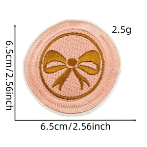 Detail of pink round patch with gold bow embroidery showing 6.5cm diameter size