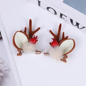 Christmas reindeer antler hair clips with brown horns and red berries on white background