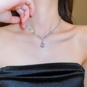 Close-up of elegant pink teardrop necklace set with shimmering pavé diamond accents