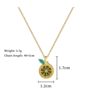 Detail view of lemon pendant with blue and green gems on a 40cm gold chain