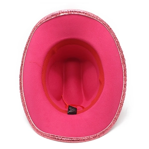 Detail view showing pink felt cowboy hat interior with red sweatband and fabric labels