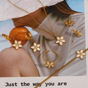 Artistic layout of 18K gold plated shell flower necklace, earrings, ring, and bracelet set
