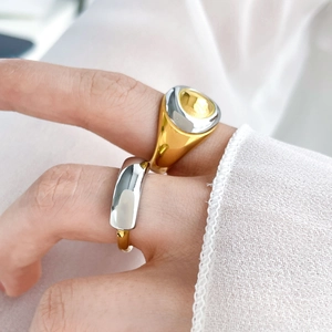 Minimalist two-tone titanium steel ring set with polished gold and silver oval design