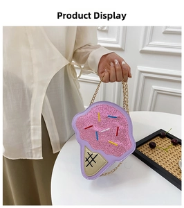 Close-up of cute ice cream shaped crossbody bag with pink sequins and gold chain strap