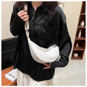 Chic white nylon half-moon crossbody bag shown on a black satin shirt outfit for a stylish look