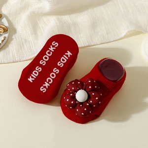 Detail of red baby floor socks featuring anti-slip grippers and a soft 3D fabric flower