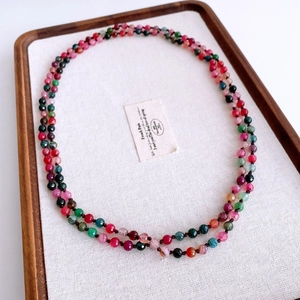 Close-up of multi-color faceted agate beaded necklace in a vintage ethnic style display