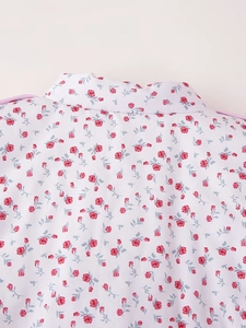 Detailed view of the mandarin collar and pink rose floral pattern on a white padded jacket