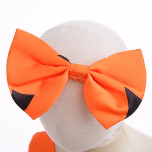 Detail of orange and black pumpkin-style Halloween bow headpiece on a mannequin