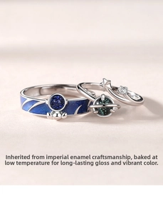Detail of s925 silver astronaut couple rings featuring deep blue enamel starry sky