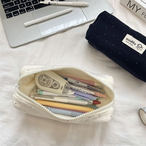 Close-up of dot pattern wool pencil cases with large capacity storage for stationery