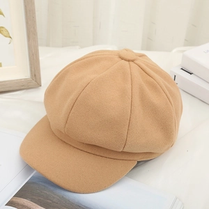 Side view of camel wool newsboy cap showing elegant fabric texture and clean minimalist style