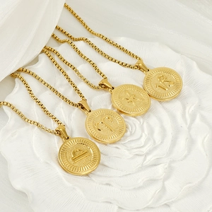 Golden titanium steel zodiac pendant necklaces with 18K plating on white floral base