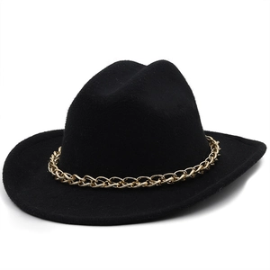 Close-up of cowboy hat showing black wool felt texture and golden metal chain detail