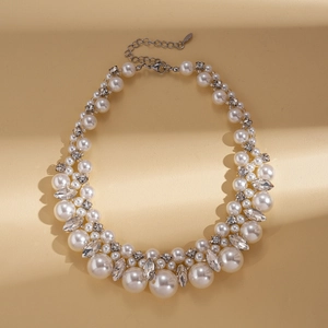 Detailed view of luxury necklace with white pearls, glittering rhinestones and silver clasp