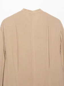 Detail of light khaki chiffon dress back with vertical seam and tailored waist design