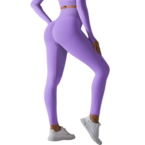 Purple high-waisted seamless yoga pants with a peach lift design and matching long-sleeved top
