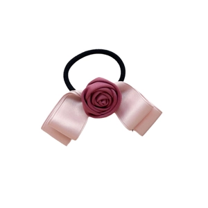 Pink ribbon bow hair tie with center rose detail on a black elastic band for women