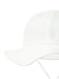 Close-up of pure white cotton baby sun hat with chin strap and soft breathable fabric