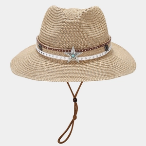 Detail of straw cowboy hat featuring metal star turquoise and vintage leather band