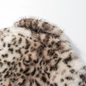 Detailed close-up of the leopard print faux fur texture with dense black and brown spots