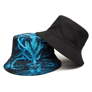 Reversible dragon print bucket hat featuring black cotton side and blue dragon graphic