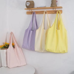 Minimalist canvas tote bags in pastel pink, purple, beige, and yellow colors