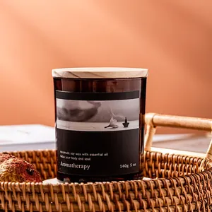 Natural soy wax aromatherapy candle in amber glass jar with wooden lid and dried decor