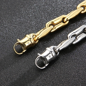 Detailed macro view of gold and silver thick oval link chains with lobster clasps