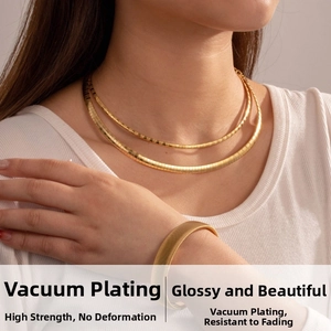 Detail of gold snake chain necklace set and wide cuff bracelet with vacuum plating finish