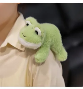 Cute light green plush frog toy accessory worn on a shoulder with soft fuzzy texture