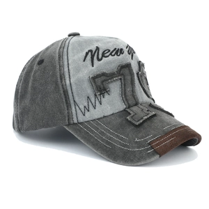 Detail of vintage patchwork denim baseball cap with 3D number 79 embroidery and distressed brim