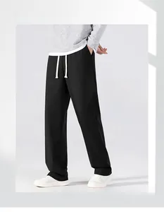 Detail of men's black straight leg casual pants featuring white contrast drawstring waist