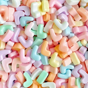 Macro shot of L-shaped colorful resin beads in macaron tones for DIY phone cases