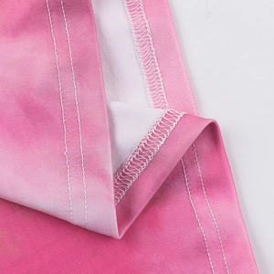 Detailed close-up of pink gradient fabric showing precision overlock and double-needle stitching
