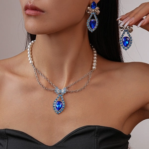 Vintage pearl necklace set with blue teardrop gemstone and diamond bow pendant