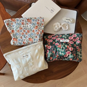 Three-piece floral fabric cosmetic bags with embossed texture and simple wish logo tags