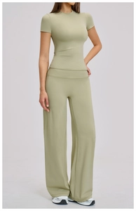 Detail of sage green brushed yoga set featuring short sleeve top and high waist wide leg pants