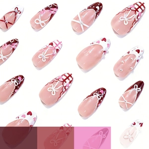 French almond press-on nails with 3D bows, pink heart designs, and pearl accents
