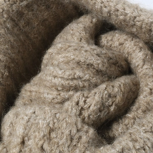 Thick cable knit beanie in warm beige featuring soft fuzzy wool texture for winter wear