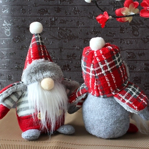 Pair of red plaid Christmas gnomes with long white beards on a woven mat decoration