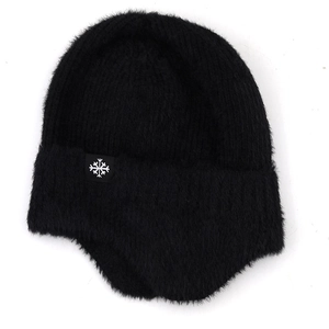 Detail of black faux fur winter hat featuring a white snowflake patch and ear flaps