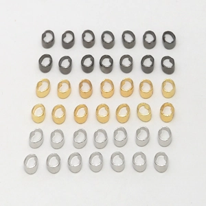 DIY jewelry connectors in gold, silver, and gun black finishes on white background
