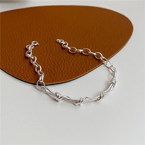 Minimalist S925 sterling silver braided wire chain bracelet on leather background