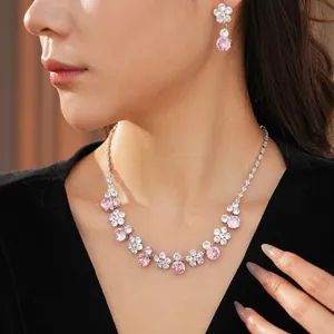 Elegant floral jewelry set with pink and white zircon crystals on a silver necklace