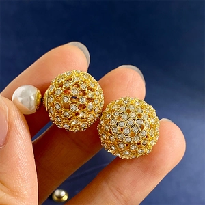 Elegant gold hollow ball earrings with sparkling crystals and white pearl accents