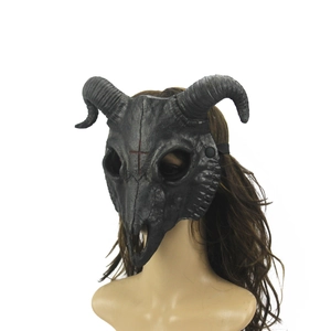 Macro view of matte black goat skull mask with spiral horns and red cross detail