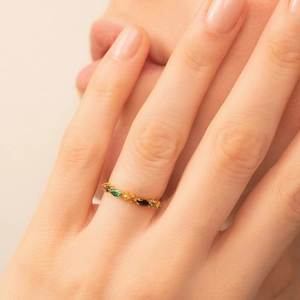 Close-up of S925 silver gold-plated ring with colorful marquise zircons worn on a finger